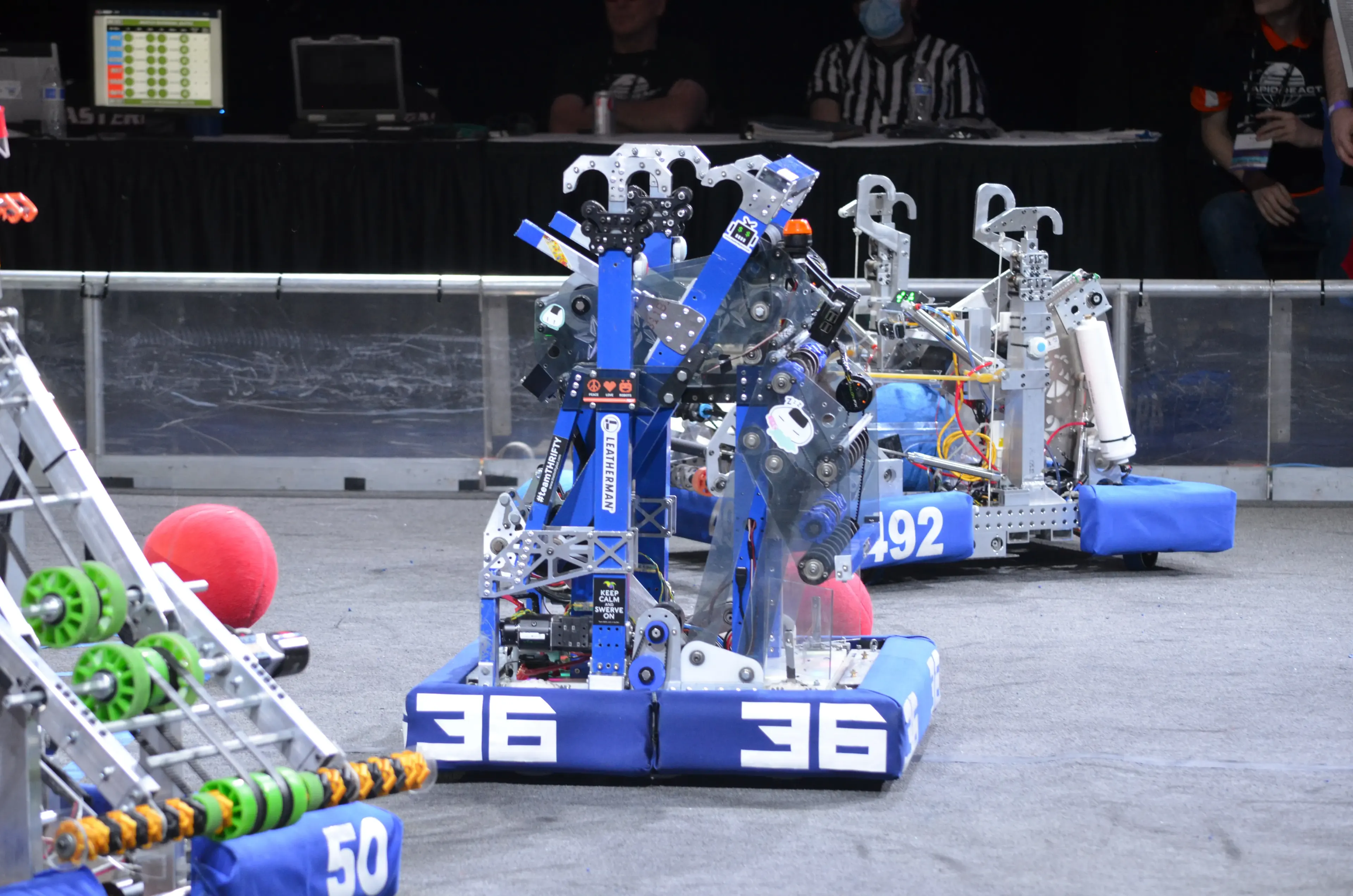 Napoleon, our robot from the 2022 robotics season, sitting still on a field along side teams' robots